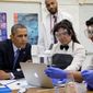 President Obama looks over students&#39; work as he visits a classroom at Bladensburg High School on Monday. At Bladensburg, the Obama administration unveiled the $107 million Youth CareerConnect program designed to &quot;deliver real-world learning opportunities for students&quot; and offer specific training in a given field before a student graduates high school. (Associated Press)
