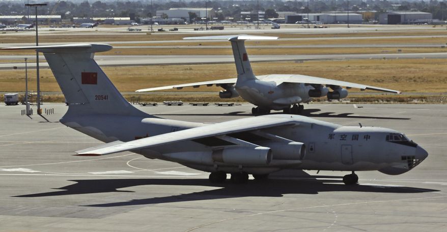 A Chinese Ilyushin IL-76s aircraft taxies past another parked on the tarmac at Perth International Airport after returning from search operations for wreckage and debris of the missing Malaysia Airlines Flight MH370, in Perth, Australia, Monday, April 7, 2014. It’s not a question most governments involved in the hunt for Flight 370 care to answer: How much has the far-flung, month-long search cost? Several Chinese ships and planes have been involved in the search, but China’s foreign ministry did not respond to questions about the expense of the effort. (AP Photo/Rob Griffith)