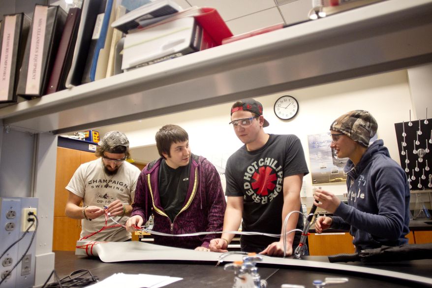 From left, University of Iowa students Sam Mate, Tom Harter, Joe Schneider, and Marie Schulz work in Pablo Carrica's Experimental Engineering course held at the UI Seamans Center for the Engineering Arts and Sciences in Iowa City, on March 27, 2014. In the past 10 years, UI's College of Engineering has grown 70 percent — 30 percent in the past four years alone. Of those graduating, 98 percent leave school with jobs that have a median starting salary of more than $60,000. (AP Photo/Iowa City Press-Citizen, Benjamin Roberts) NO SALES