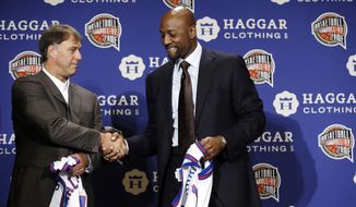 Former NBA player Sarunas Marciulionis, of Lithuania, greets former NBA player Alonzo Mourning, right, on stage during the Naismith Memorial Basketball Hall of Fame class of 2014 announcement, Monday, April 7, 2014, in Dallas. (AP Photo/Charlie Neibergall)