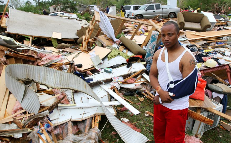 Damian Barnes's mobile home was thrown 20 feet and destroyed during a tornado that struck the area Monday, March 7, 2014, near Collins, Miss. Barnes along with his girlfriend and two children were asleep when the tornado destroyed it leaving Barnes injured and having to pull the others from the wreckage. (AP Photo/Hattiesburg American, George Clark)