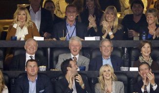 From center left, Dallas Cowboys owner Jerry Jones, former presidents Bill Clinton and George W. Bush and former first lady Laura Bush as well as Cowboys head coach Jason Garrett, second from top left, watch action between Connecticut and Kentucky during the first half of the NCAA Final Four tournament college basketball championship game Monday, April 7, 2014, in Arlington, Texas. (AP Photo/Tony Gutierrez) 