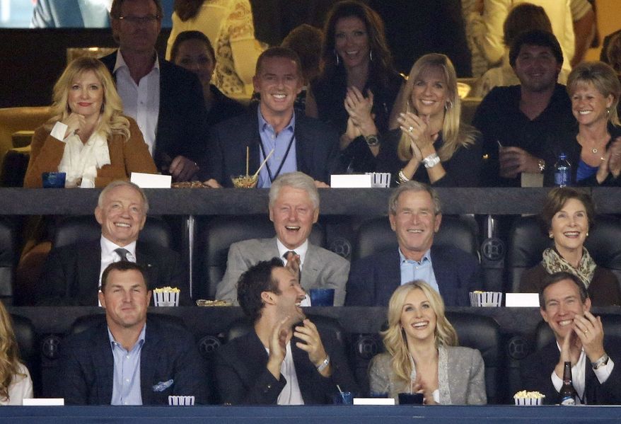 From center left, Dallas Cowboys owner Jerry Jones, former presidents Bill Clinton and George W. Bush and former first lady Laura Bush as well as Cowboys head coach Jason Garrett, second from top left, watch action between Connecticut and Kentucky during the first half of the NCAA Final Four tournament college basketball championship game Monday, April 7, 2014, in Arlington, Texas. (AP Photo/Tony Gutierrez)