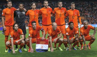 FILE - In this Oct. 11, 2013 file photo, Dutch soccer team poses prior the start the Group D World Cup qualifying soccer match between Netherlands and Hungary, at Arena stadium in Amsterdam, Netherlands. Background from left: Jeffrey Bruma, Michel Vorm, Daryl Janmaat, Ron Vlaar, Kevin Strootman, and Rafael van der Vaart. Foreground from left: Daley Blind, Robin van Persie, Arjen Robben, Jeremain Lens and Nigel de Jong.  (AP Photo/Peter Dejong, File)