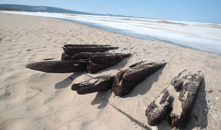In this photo taken on April 6, 2014, the ribs of a shipwreck jut from the sand on the Lake Michigan shoreline north of Glen Arbor, Mich., near the Crystal River. The harsh winter and Lake Michigan waves have revealed the wreck of the large boat along a northwestern Lower Peninsula beach that may be more than 100 years old. (AP Photo/Traverse City Record-Eagle, Nathan Payne) MANDATORY CREDIT