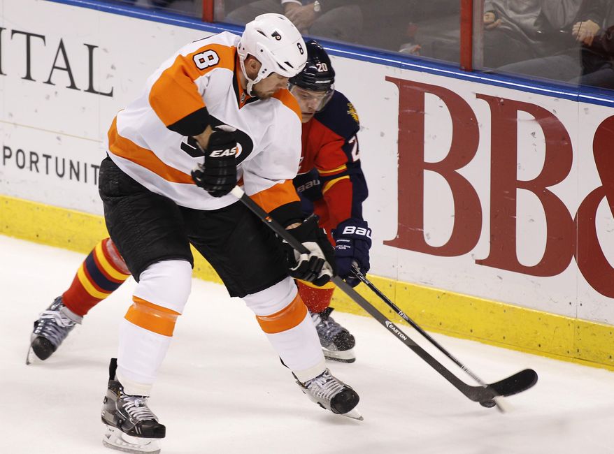 Philadelphia Flyers defenseman Nicklas Grossmann (8) and Florida Panthers left wing Sean Bergenheim (20) fight for the puck during the second period of an NHL hockey game in Sunrise, Fla., on Tuesday, April 8, 2014. (AP Photo/Terry Renna)