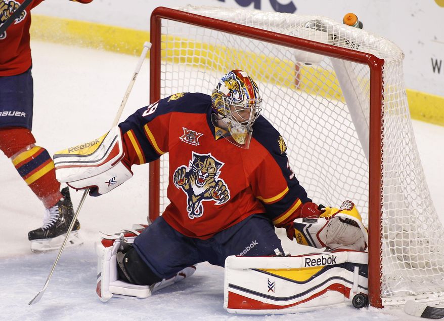 Florida Panthers goalie Dan Ellis (39) stops the puck during the first period of an NHL hockey game in Sunrise, Fla., on Tuesday, April 8, 2014. (AP Photo/Terry Renna)