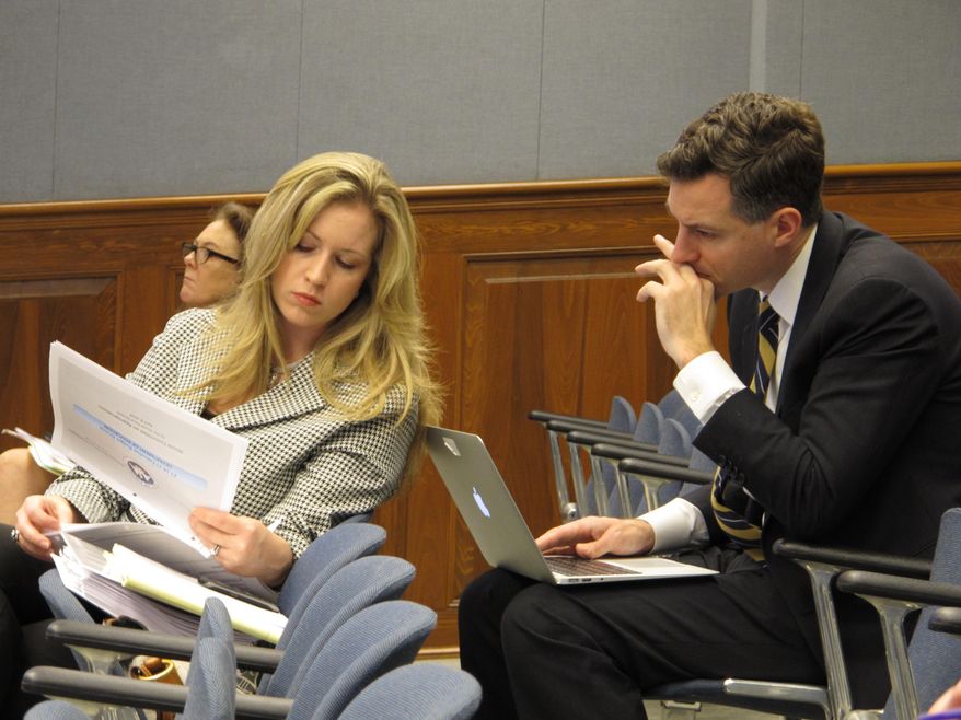 Erin Bendily, assistant superintendent with the Department of Education, and Louisiana Superintendent of Education John White review budget information provided to the House Appropriations Committee on Tuesday, April 8, 2014, in Baton Rouge, La. (AP Photo/Melinda Deslatte)