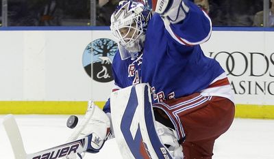 New York Rangers goalie Henrik Lundqvist, of Sweden, stops a shot on the goal from Carolina Hurricanes&#39; Alexander Semin during the first period of an NHL hockey game Tuesday, April 8, 2014, in New York. (AP Photo/Frank Franklin II)