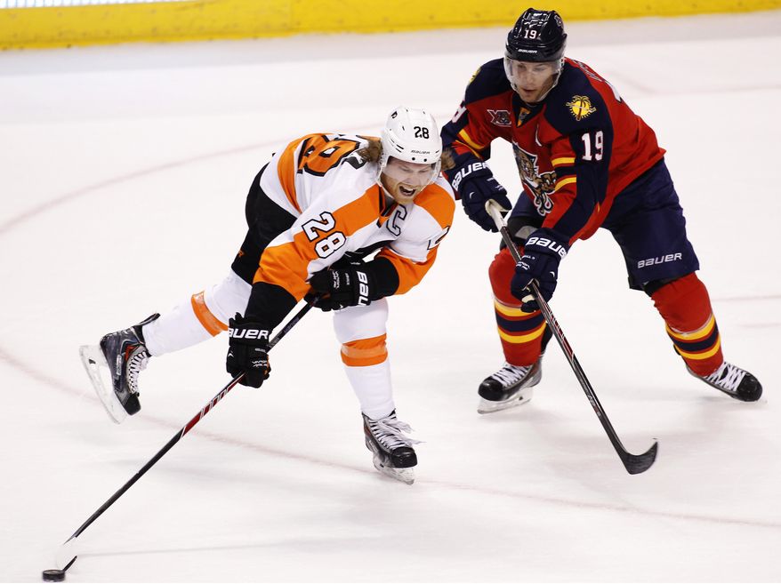 Philadelphia Flyers center Claude Giroux (28) carries the puck as Florida Panthers right wing Scottie Upshall (19) defends during the first period of an NHL hockey game in Sunrise, Fla., on Tuesday, April 8, 2014. (AP Photo/Terry Renna)