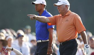 Tiger Woods, left, walks to the 12th tee with Mark O&#39;Meara during a practice round for the Masters golf tournament Monday, April 2, 2012, in Augusta, Ga. (AP Photo/Chris O&#39;Meara)