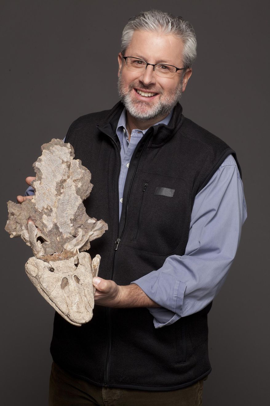 This photo released by PBS shows host Neil Shubin of "Your Inner Fish," holds a cast of a fossilized Tiktaalik roseae. The three-part documentary series examines the evolution of the human body. It debuts Wednesday, April 9, 2014, on PBS. (AP Photo/PBS, Courtesy of Nathaniel Chadwick Copyright Tangled Bank Studios, LLC)