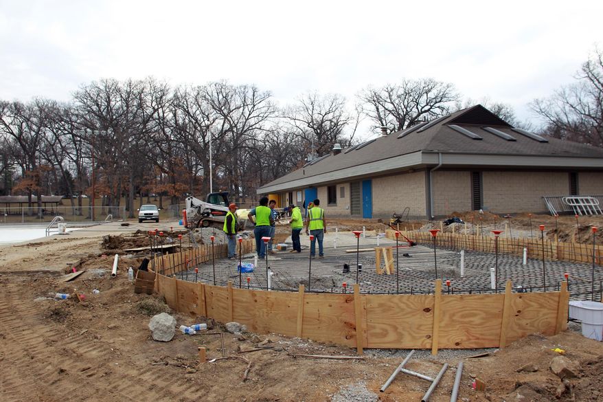 In this photo taken on Monday, April 7, 2014, construction continues at the City Park pool in Iowa City, Iowa. Officials in Iowa City are seeking ideas to redesign the popular park after flooding last summer left it strewn with sand and debris. (AP Photo/Iowa City Press-Citizen, David Scrivner) NO SALES