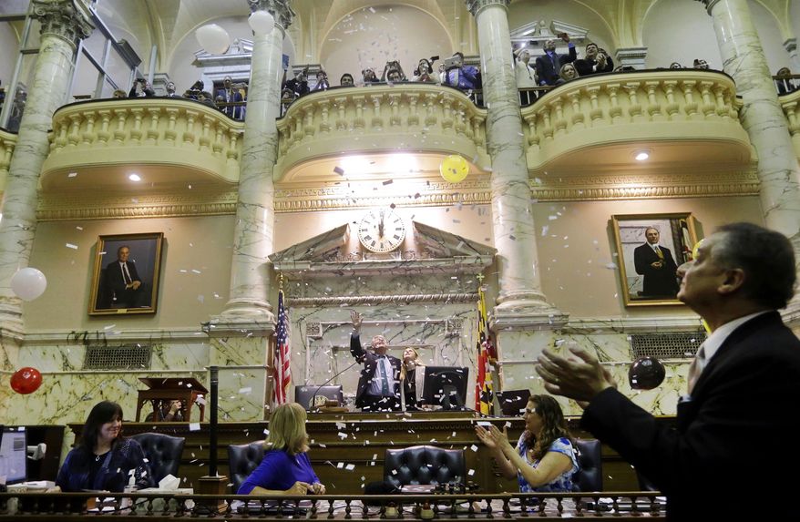 Confetti and balloons fall as members of the Maryland House of Delegates celebrate the end of  the 2014 legislative session in Annapolis, Md., early Tuesday, April 8, 2014. (AP Photo/Patrick Semansky)