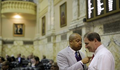 Rep. Shawn Tarrant, D-Baltimore City, left, chats with Rep. Rick Impallaria, R-Baltimore County, in the Maryland House of Delegates chamber in Annapolis, Md., Monday, April 7, 2014, the final day of the 2014 legislative session. (AP Photo/Patrick Semansky)