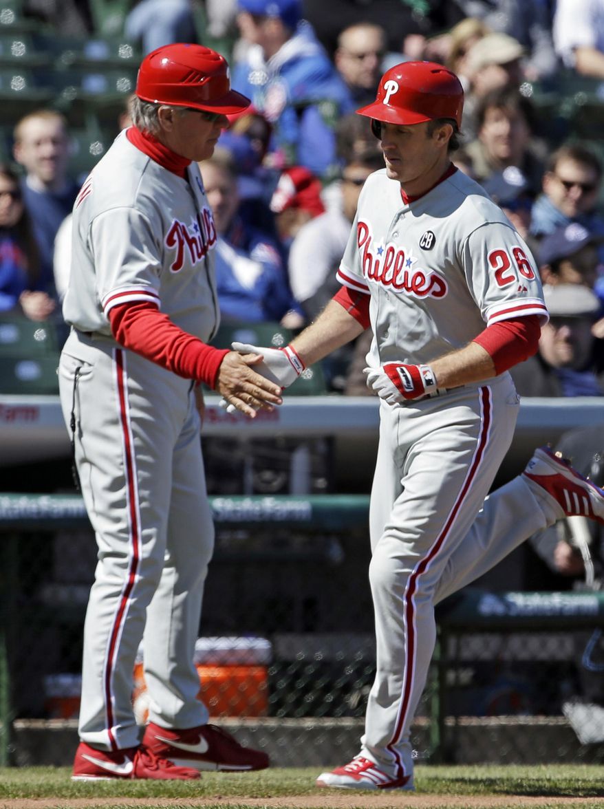 Philadelphia Phillies&#x27; Chase Utley, right, celebrates with third base coach Pete Mackanin after hitting a solo home run during the first inning of a baseball game against the Chicago Cubs in Chicago, Saturday, April 5, 2014. (AP Photo/Nam Y. Huh)
