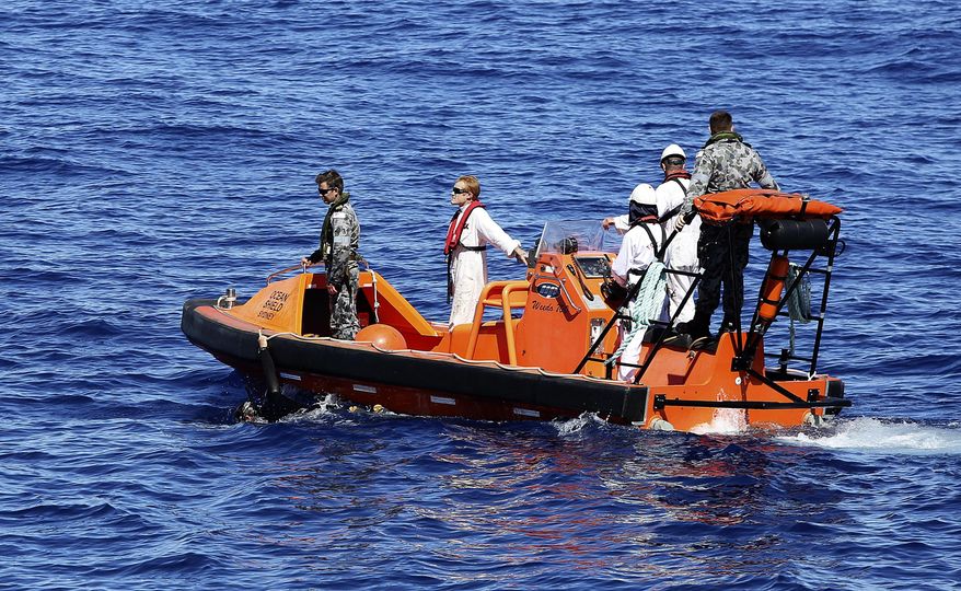 In this April 7, 2014 photo provided by the Australian Defense Force, a fast response craft manned by members from the Australian Defense's ship Ocean Shield tows Able Seaman Clearance Diver Michael Arnold as they scan the water for debris of the missing Malaysia Airlines Flight 370 in the southern Indian Ocean. Up to 14 planes and as many ships were focusing on a single search area covering 77, 580 square kilometers (29,954 square miles) of ocean, 2,270 kilometers (1,400 miles) northwest of the Australian west coast city of Perth, Australia. (AP Photo/Australian Defense Force, LSIS Bradley Darvill) EDITORIAL USE ONLY
