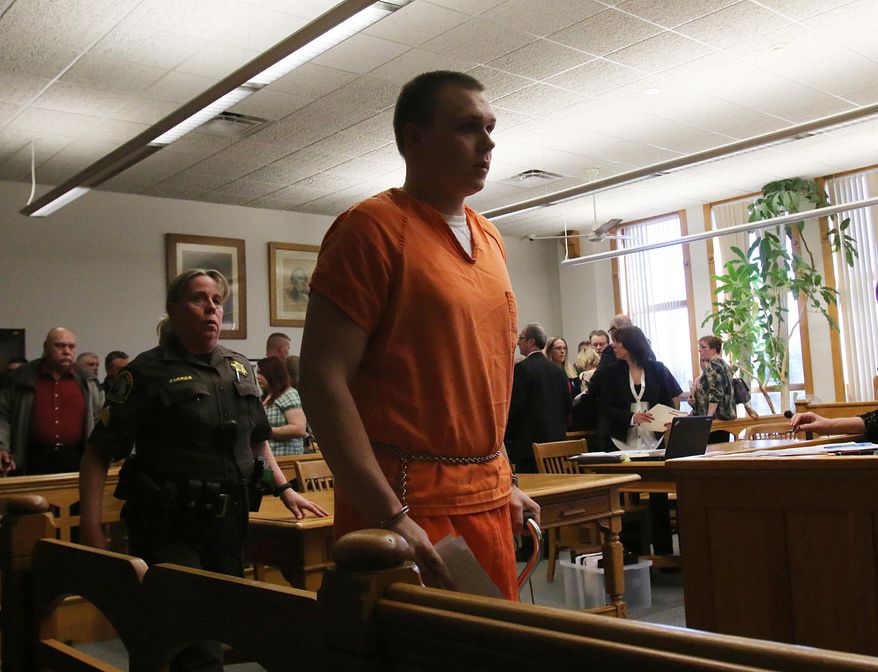 Eric Knysz leaves the courtroom following his sentencing on Tuesday, April 8, 2014. Knysz was sentenced to life in prison by Mason County's 51st Circuit Court Judge Richard I. Cooper in Ludington, Mo. Knysz was convicted on February 25, 2014 of killing Michigan State Police Trooper Paul K. Butterfield II during a routine traffic stop on September 9, 2013 in rural Mason County. Mason County Sheriff Office Sgt. Bethany Carrier is pictured behind Knysz and his father, John Knysz is pictured in the background left. (AP Photo/The Muskegon Chronicle, Ken Stevens)