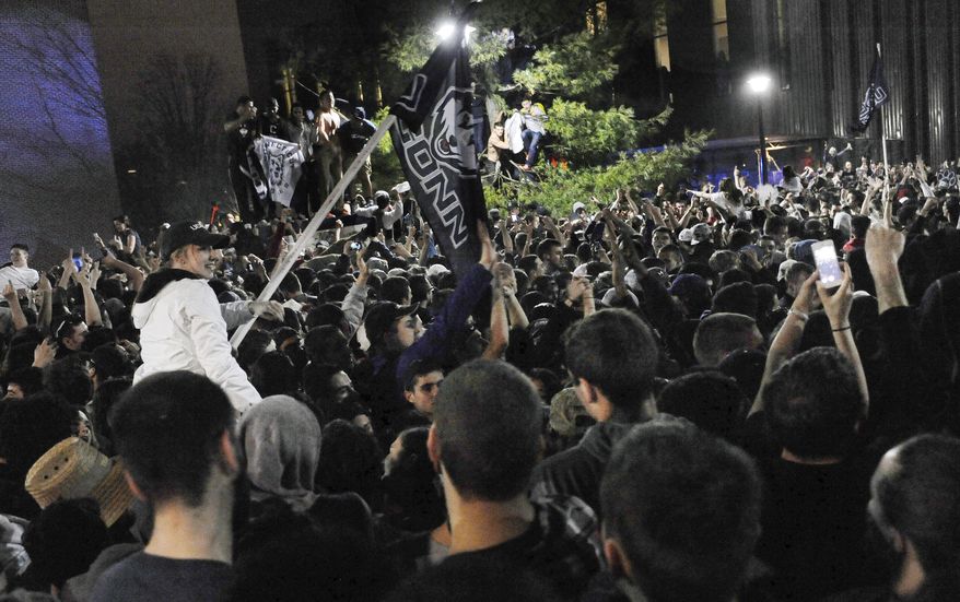 Connecticut students celebrate their team's 60-54 victory over Kentucky in the NCAA Final Four tournament college basketball championship game Monday, April 7, 2014, in Storrs, Conn. (AP Photo/Jessica Hill)