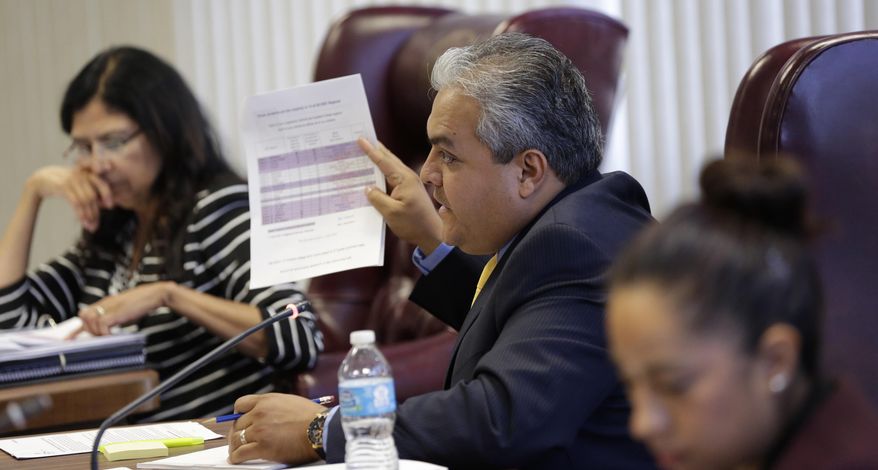 State Board of Education member Ruben Cortez Jr., center, questions a speaker during a hearing, Tuesday, April 8, 2014, in Austin, Texas. The Texas Board of Education is considering a proposal to add a Mexican-American studies course as a statewide high school elective. (AP Photo/Eric Gay)