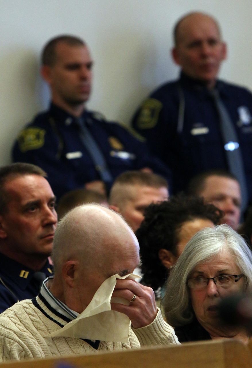 Paul T. Butterfield, the father of slain Michigan State Police Trooper Paul K. Butterfield II wipes a tear as Jennifer Sielski, (not pictured) fiancee of Butterfield II makes a statement in court during the sentencing of Eric John Knysz on Tuesday, April 8, 2014. Knysz was sentenced to life in prison with no chance of parole by Mason County's 51st Circuit Court Judge Richard I. Cooper in Ludington. Knysz was convicted on Feb. 25, 2014 of killing Michigan State Police Trooper Paul K. Butterfield II during a routine traffic stop on September 9, 2013 in rural Mason County. (AP Photo/The Muskegon Chronicle, Ken Stevens)
