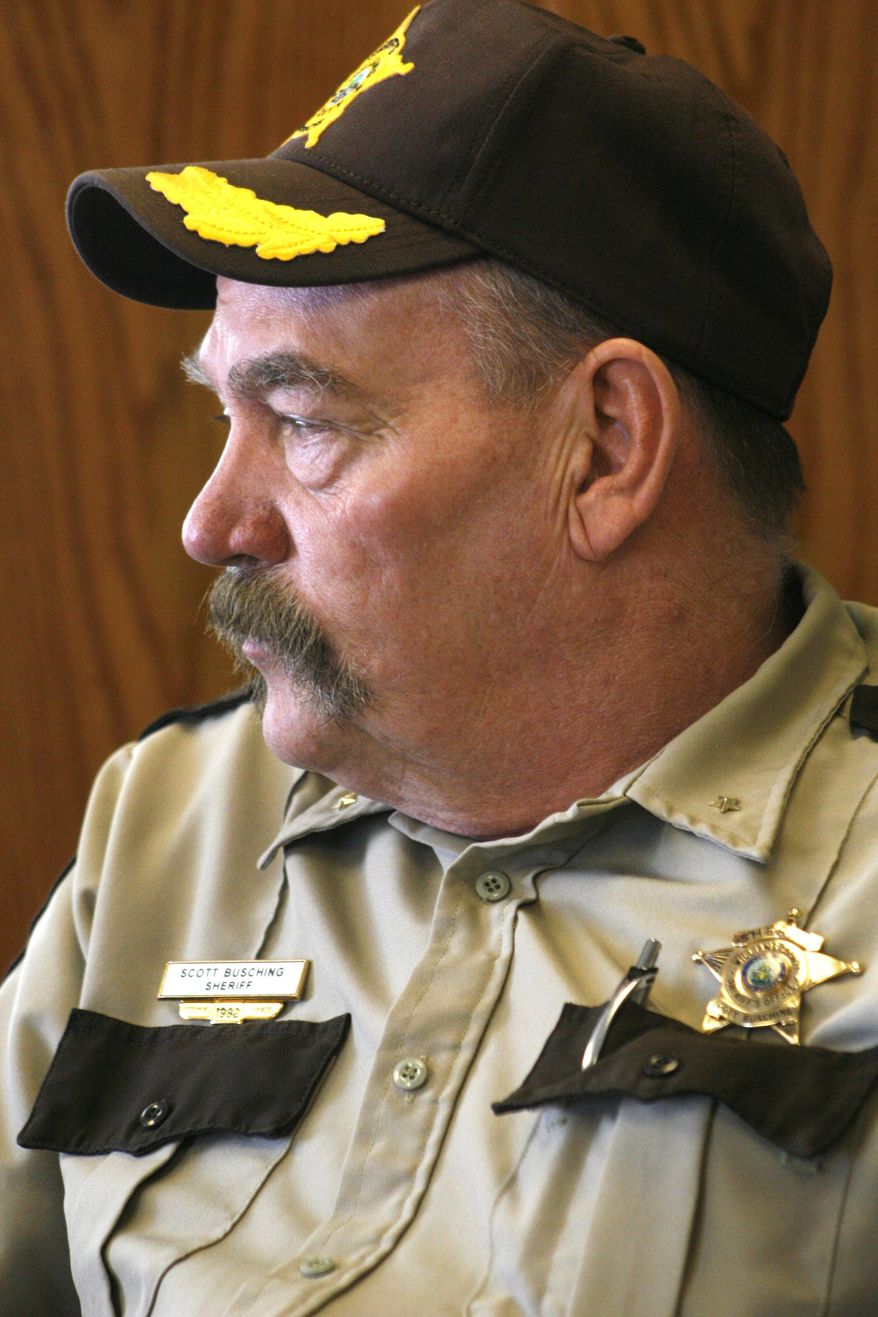 ADVANCE FOR USE SUNDAY, APRIL 13, 2014 AND THEREAFTER - Williams County, N.D. Sheriff Scott Busching sits at his desk in Williston, N.D. on Tuesday, Feb. 25, 2014. Busching says the new county jail, which he oversees, is already overcrowded, with much of the crime tied to alcohol abuse and illegal drugs. He attributes the increase in crime to the growing population brought in by the latest oil boom in the region known as the Baaken, which includes northwest North Dakota and northeastern Montana. (AP Photo/Martha Irvine)