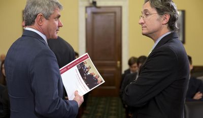 House Homeland Security Committee Chairman Rep. Michael McCaul, R-Texas, left, holds a document about the Boston Marathon Bombing by Harvard Professor Herman “Dutch” Leonard, right, on Capitol Hill in Washington, Wednesday, April 9, 2014, prior to the start of the committee&#x27;s hearing on the bombings leading up to the year anniversary of the attack. (AP Photo/Jacquelyn Martin)