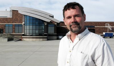 In this April 1, 2014 photo Mike Isaacs, airport manager at Pierre Regional Airport, stands outside the airport in Pierre, S.D. Great Lakes airlines' struggle with a new set of strict guidelines has inconvenienced travelers and hurt business at the airport. Doctors have missed surgeries and people have missed weddings, according to complaints. Despite cancellations and drop in routes Isaacs feels travel will improve. (AP Photo/Nora Hertel)