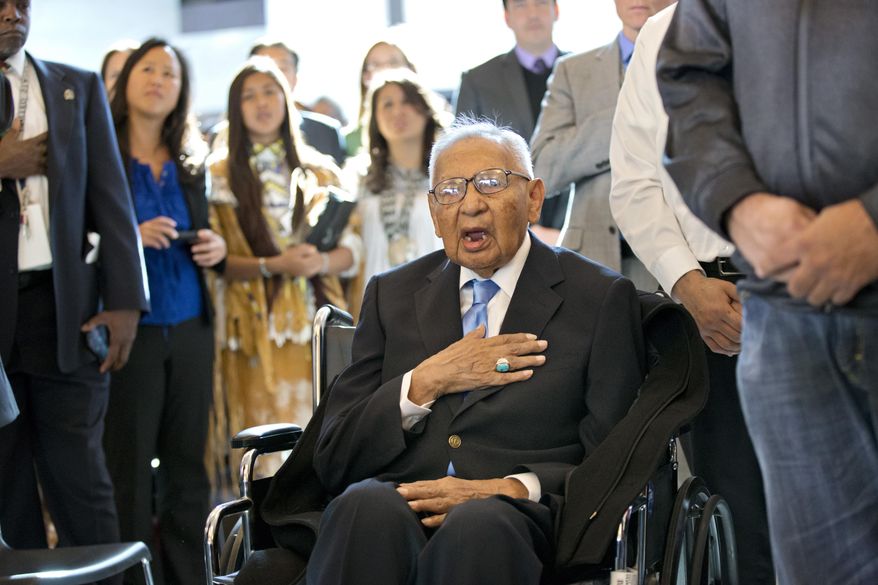 File - In this Nov. 20, 2013 file photo, Edmond Harjo, 96, of the Seminole Nation of Oklahoma, and one of the last surviving code talkers, places his hand over his heart as the American flag is presented during a Congressional Gold Medal ceremony on Capitol Hill in Washington. Harjo died March 31, 2014, at Mercy Hospital in Ada, Okla., according to the Swearingen Funeral Home. Harjo's nephew, Richard Harjo, said his uncle had a heart attack. He was 96. (AP Photo/J. Scott Applewhite, File)