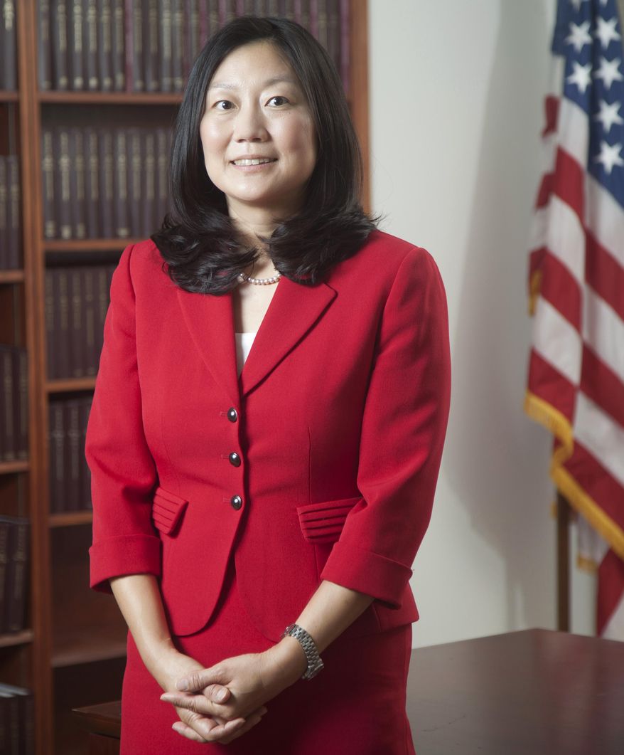 In this 2013 photo, U.S. District Judge Lucy Koh poses for a picture, in San Francisco. Koh has become increasingly frustrated during the first few days of the trial pitting Apple against Samsung because personal Wi-Fi signals interfere with an internal network she relies on for a real-time transcript of the proceedings. (AP Photo/The Recorder, Jason Doiy)