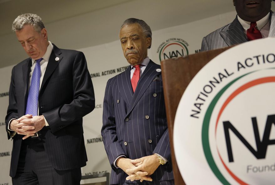 New York City Mayor Bill de Blasio, left, and Rev. Al Sharpton bow their heads for the opening prayer of the National Action Network convention in New York, Wednesday, April 9, 2014. The 16th annual convention will run through April 12, 2014. (AP Photo/Seth Wenig)
