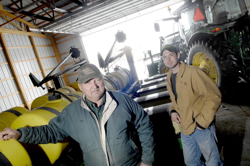 In this April 3, 2014 photo, farmers Dennis Renner and his son, Lance, are seen at their farm where they are waiting for the snow to melt and the ground to dry so they can start spring planting their crops south of Mandan, N.D. Last week's spring blizzard that dumped up to 20 inches of snow in parts of North Dakota will delay spring planting. Farmers on average now intend to start fieldwork by April 26, according to the National Agricultural Statistics Service. Some farmers aren't too far removed from finishing up last year's harvest, due to an early October blizzard that forced some producers to leave crops in the field over the winter. Dennis Renner said that he harvested sunflowers in January and the last of his corn in February. (AP Photo/The Bismarck Tribune, Mike McCleary)