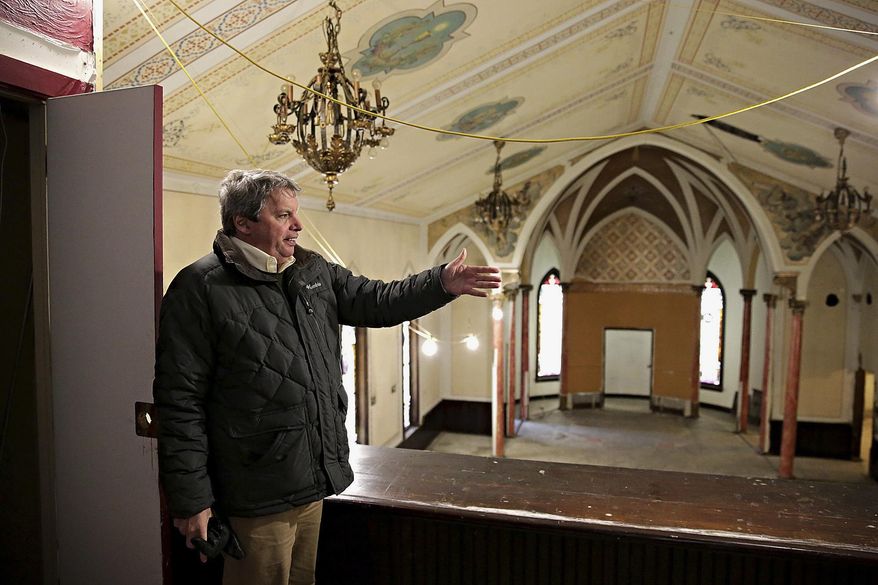 In this March 19, 2014 photo, Plainfield, Ill. village planner Michael Garrigan gives a tour of the dilapidated St. Mary’s Catholic Church in Plainfield,. The building was acquired by the village and minimally restored. It has attracted interest from potential business developers. (AP Photo/The Herald-News, Rob Winner) MANDATORY CREDIT