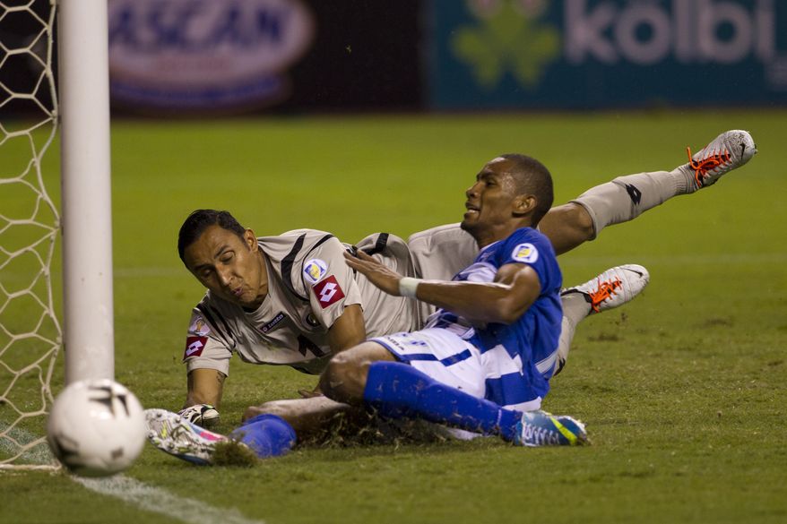 FILE - In this June 7, 2013, file photo, Honduras' Jerry Bengtson misses a chance to score against Costa Rica's goalkeeper Keilor Navas during a 2014 World Cup qualifying soccer match in San Jose, Costa Rica. The Costa Rican squad will face Uruguay, England and Italy in the northeastern city of Fortaleza. (AP Photo/Moises Castillo, File)