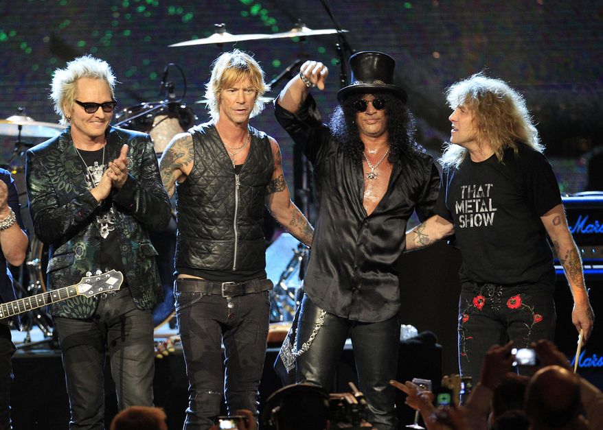 FILE - This April 15, 2012 file photo shows Guns N' Roses, from left, Matt Sorum, Duff McKagan, Slash and Steven Adler, after their performance following induction into the Rock and Roll Hall of Fame, in Cleveland. Frontman Axl Rose decided to skip the ceremony because it didn't "appear to be somewhere I'm actually wanted or respected." Guitarist Slash, bassist McKagen and drummer Adler, however, did take the stage, performing together for the first time in nearly two decades. (AP Photo/Tony Dejak, file)