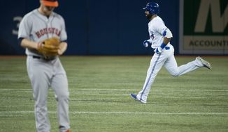 Toronto Blue Jays Jose Bautista, right, rounds the bases past Houston Astros starting pitcher Brett Oberholtzer, left, after hitting a solo home run during the first inning of the MLB American League baseball game in Toronto on Tuesday, April 8, 2014. (AP Photo/The Canadian Press, Nathan Denette)