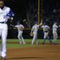 New York Mets players high-five each other as Atlanta Braves&#x27; Jason Heyward, left, walks off the field after flying out in the ninth inning to end a baseball game, Tuesday, April 8, 2014, in Atlanta. New York won 4-0. (AP Photo/David Goldman)