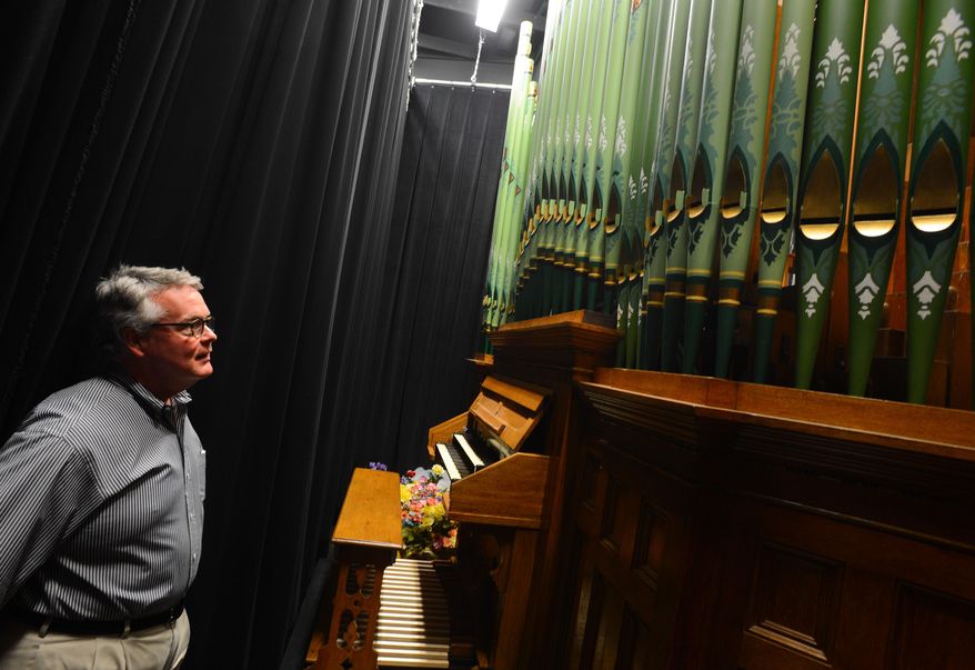 In this photo taken on April 2, 2014, Guy McClure looks at the beautiful pipe organ, made in 1892, which was part of the renovation of the historic McCandless Hall at Athens State University in Athens, Ala. The organ is rare with only between 500 and 1,000 remaining in use. The organ restoration cost $100,000 and was part of a $4 million restoration of McCandless Hall. (AP Photo/The Decatur Daily, Gary Cosby Jr.)