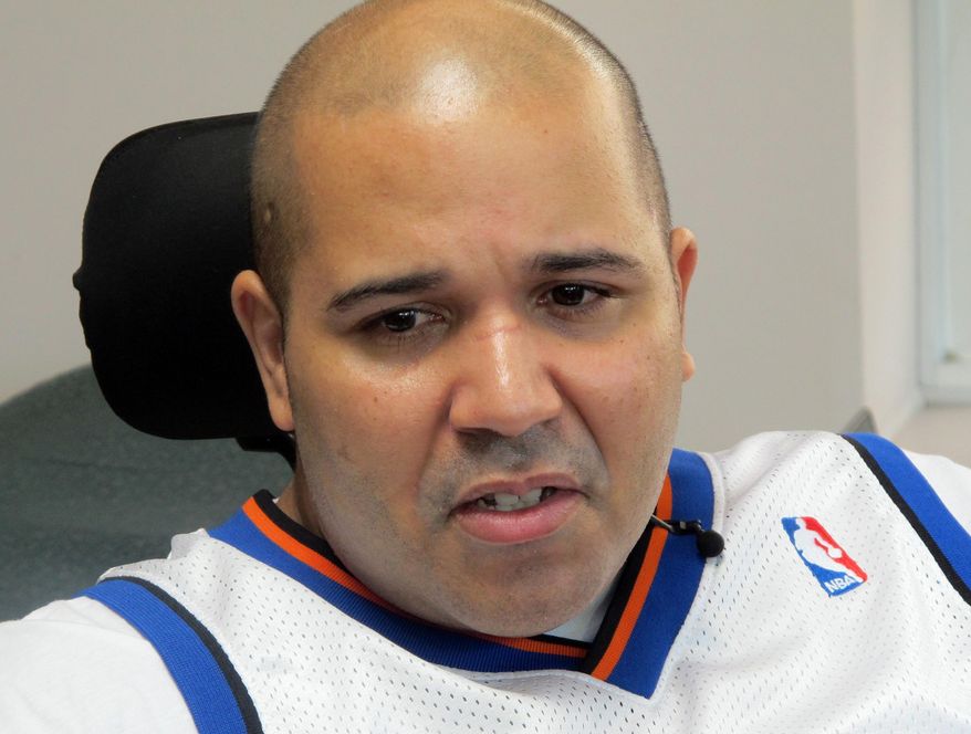 Samuel Rivera of Ossining, N.Y., speaks with reporters Wednesday, April 9, 2014, in White Plains, N.Y., about the injuries he received in a Dec. 1, 2013, Metro-North Railroad derailment. Rivera, a Metro-North Railroad mechanic, says he was paralyzed in the deadly commuter train derailment in New York City and is suing for $100 million. The lawsuit says Rivera, a passenger on the train that derailed, suffered injuries including spinal cord damage that resulted in quadriplegia. (AP Photo/Jim Fitzgerald)