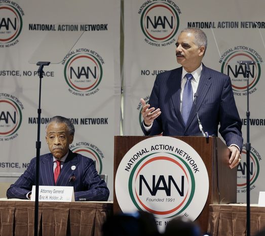 Rev. Al Sharpton, left, listens as U.S. Attorney General Eric Holder speaks at the National Action Network convention in New York on April 9. (AP Photo/Seth Wenig)