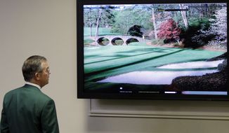 Chairman of Augusta National Golf Club Billy Payne looks at television monitor before his news conference at the Masters golf tournament in Augusta, Ga., Wednesday, April 7, 2010. The tournament begins Thursday, April, 8. (AP Photo/Rob Carr)