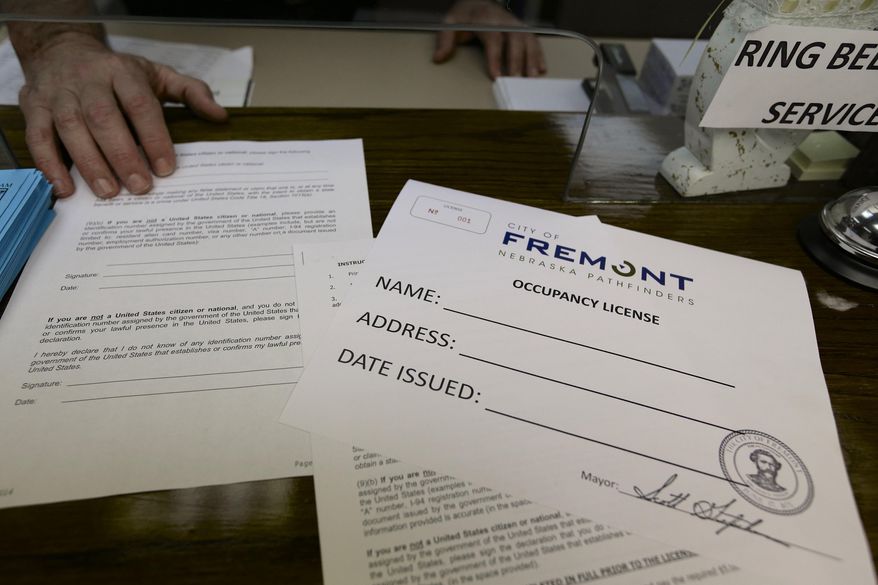 Application forms and an occupancy license certificate are seen at the police station in Fremont, Neb., Wednesday, April 9, 2014, where these licenses will be issued beginning Thursday as part of the city's ordinance aimed at combating illegal immigration. (AP Photo/Nati Harnik)