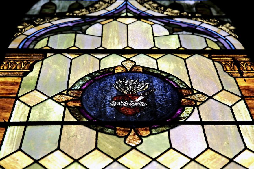 This March 19, 2014 photo shows the original stained glass is seen inside inside the dilapidated St. Mary’s Catholic Church in Plainfield, Ill. The building was acquired by the village and minimally restored. It has attracted interest from potential business developers. (AP Photo/The Herald-News, Rob Winner) MANDATORY CREDIT