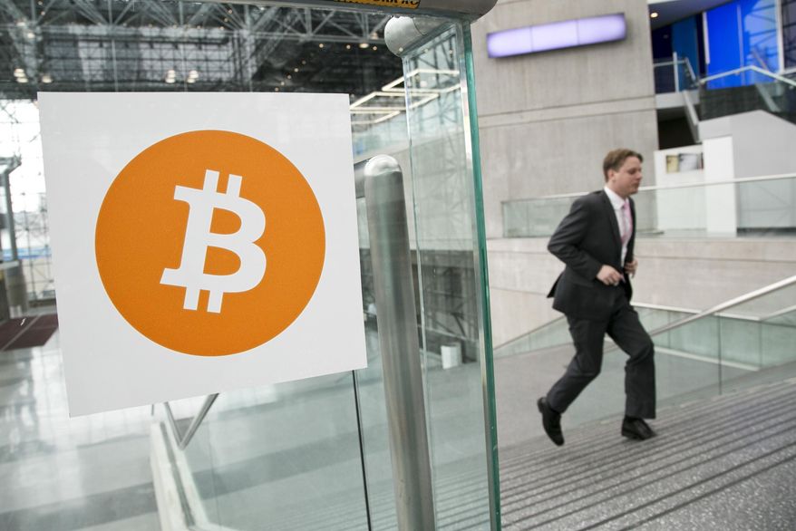 A man arrives for the Inside Bitcoins conference and trade show in New York, April 7, 2014. (Associated Press) ** FILE **