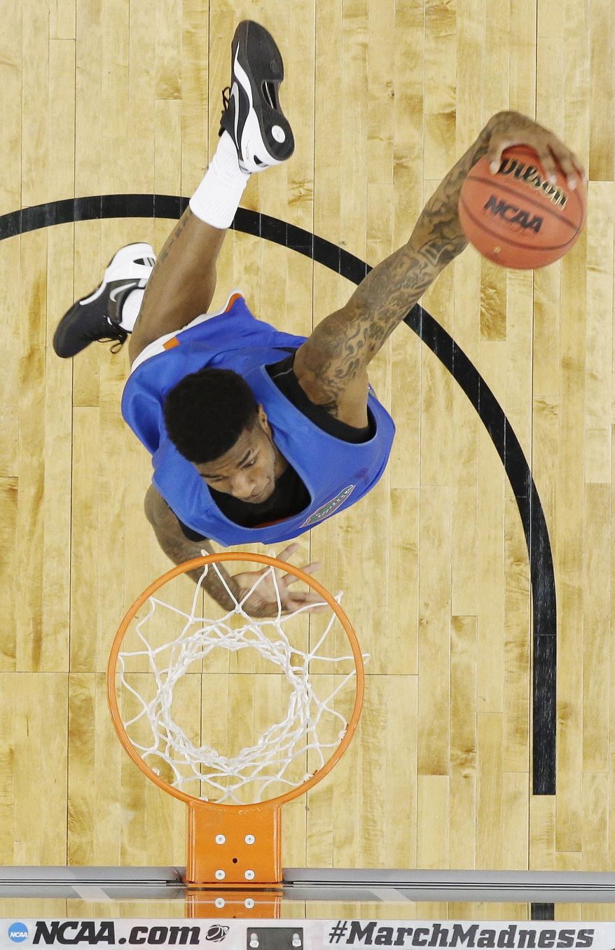 Florida forward Chris Walker dunks during practice for an NCAA Final Four tournament college basketball semifinal game Friday, April 4, 2014, in Dallas. Florida plays Connecticut on Saturday, April 5, 2014. (AP Photo/David J. Phillip)
