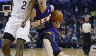 Phoenix Suns guard Goran Dragic (1) gets around New Orleans Pelicans forward Darius Miller (2) in the first half of an NBA basketball game in New Orleans, Wednesday, April 9, 2014. (AP Photo/Bill Haber)