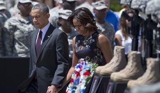President Barack Obama and first lady Michelle Obama arrive for a memorial ceremony, Wednesday, April 9, 2014, at Fort Hood Texas, for those killed there in a shooting last week. President Barack Obama is reprising his role as chief comforter as he returns once again to a grief-stricken corner of America to mourn with the families of those killed last week at Fort Hood and offer solace to the nation.(AP Photo/Carolyn Kaster)