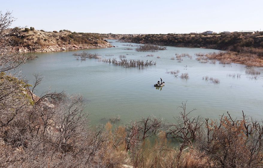 ADVANCE FOR RELEASE MONDAY, APRIL 14, 2014, AND THEREAFTER- In this March 18, 2014 photo, fishermen troll for their next catch at Lake Alan Henry in Justiceburg, Texas. The lake lost roughly 4 billion gallons of water to evaporation in 2011, thanks to a lingering drought and sweltering temperatures and still more water is simply missing, according to federal government data. (AP Photo/Lubbock Avalanche-Journal, Stephen Spillman)