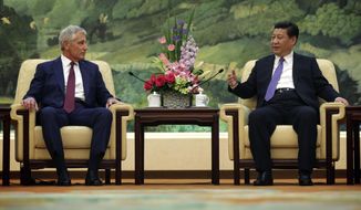 U.S. Defense Secretary Chuck Hagel, left, meets with Chinese President Xi Jinping at the Great Hall of the People Wednesday, April 9, 2014 in Beijing, China. (AP Photo/Alex Wong, Pool)