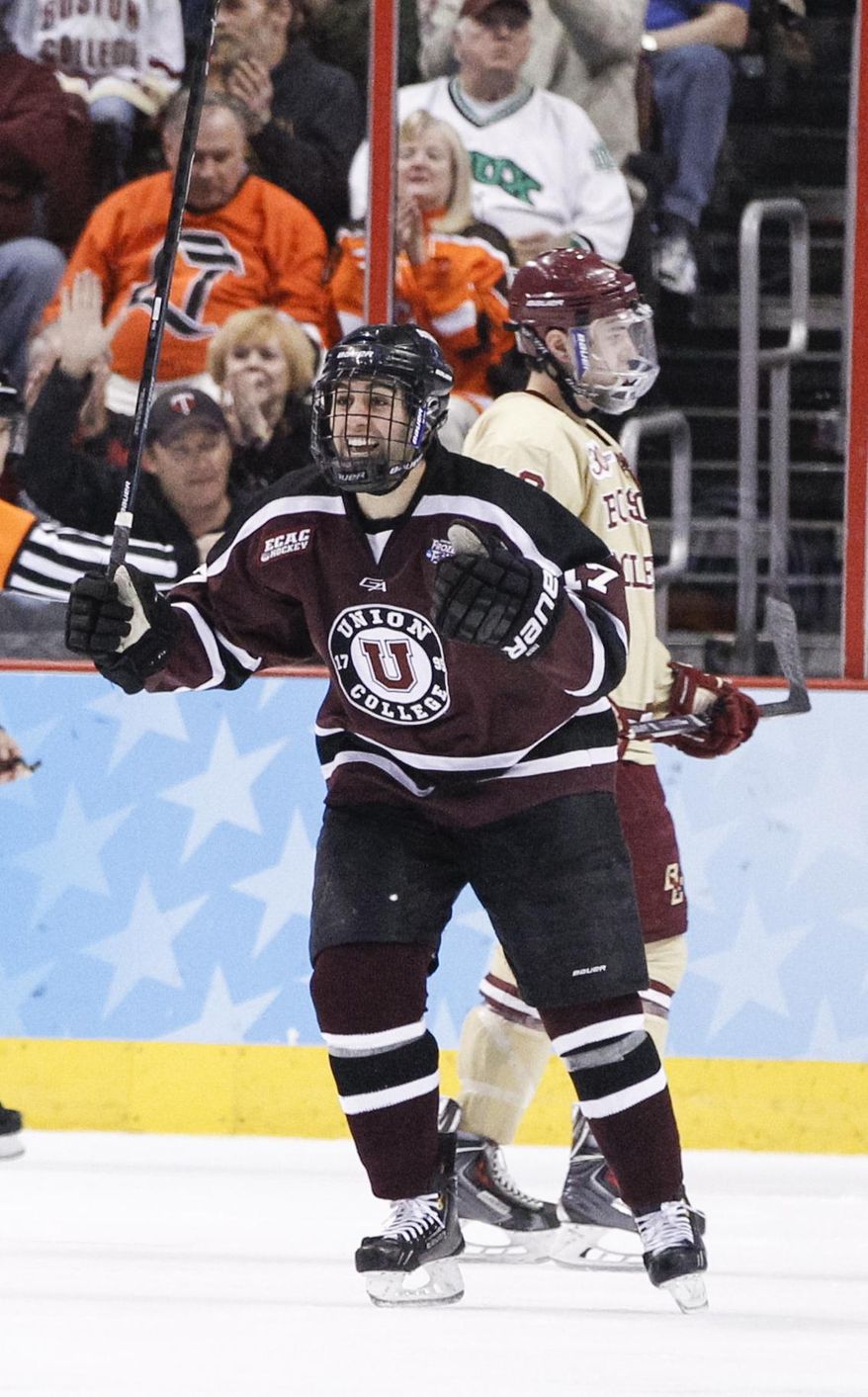 Union's Daniel Ciampini, front, reacts to scoring his second goal with Boston College's Michael Sit, back skating behind during the third period of an NCAA men's college hockey Frozen Four tournament game on Thursday, April 10, 2014, in Philadelphia. Union College won 5-4. (AP Photo/Chris Szagola)